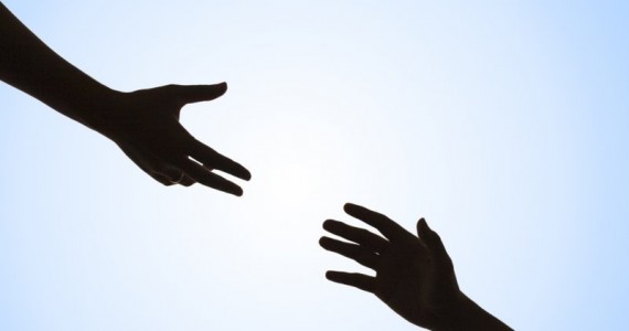 two hands outstretched from opposite ends