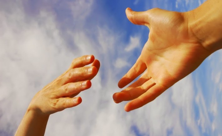 two hands reaching out to each other in kindness