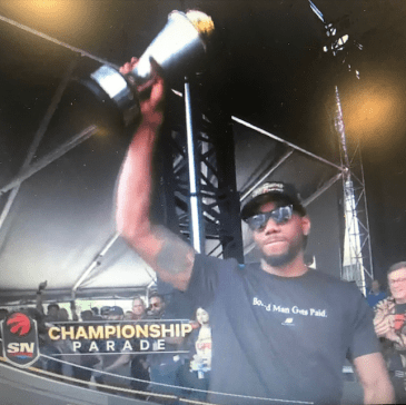 Person holding trophy in the air.