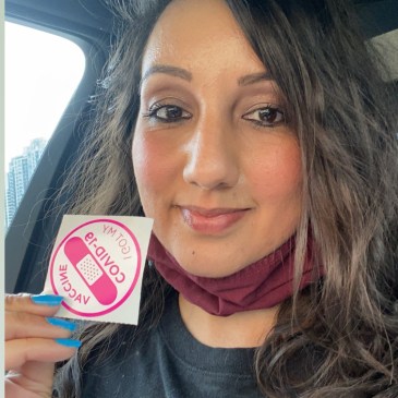 Person holding up sticker.