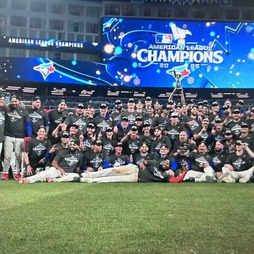 The Toronto Blue Jays posing for a team photo after winning the ALCS championship.