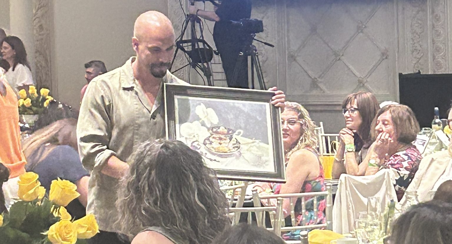Man holding up a picture