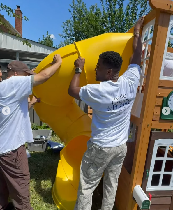 Two people building a slide for playground