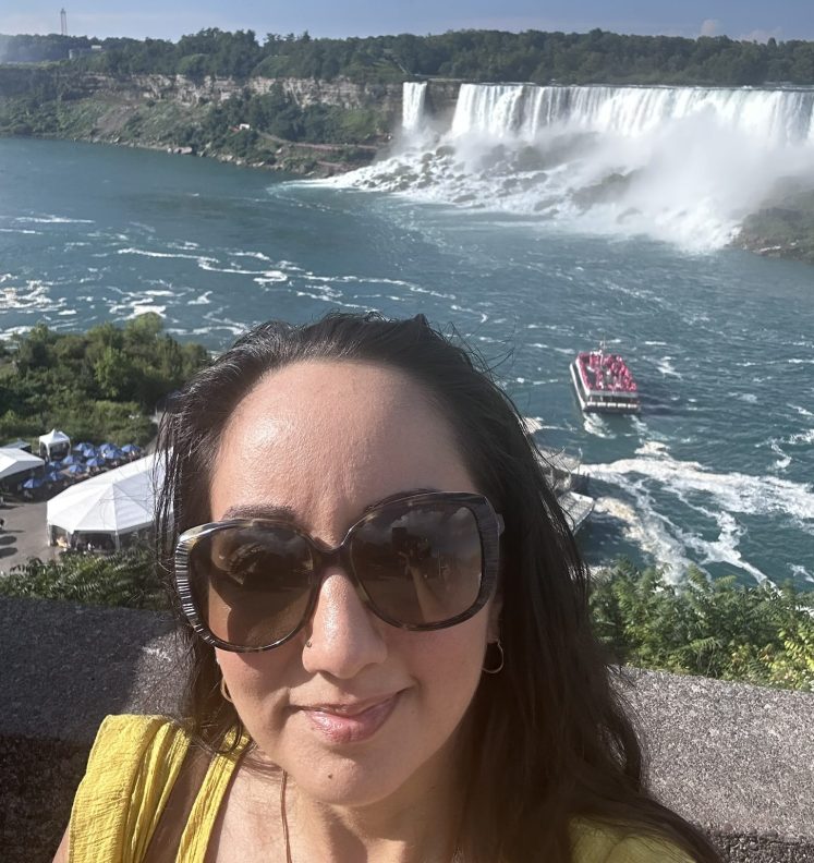 Woman taking a selfie in front of the falls